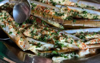 Steamed razor clams with beurre blanc sauce.